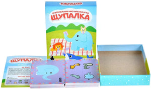 Настольная игра Щупалка от Sovabooks для развития ловкости и командной игры, изображены игровые компоненты на столе.