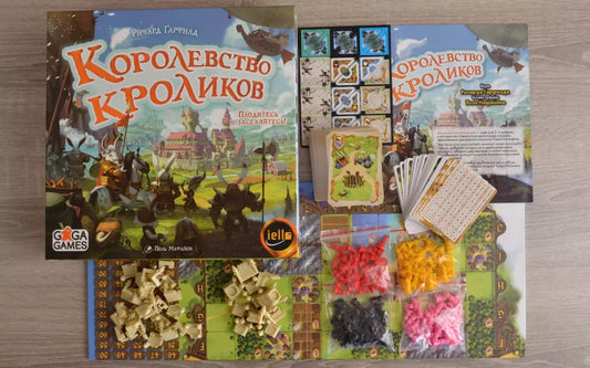 Настольная игра "Королевство кроликов" от Sovabooks для семейных развлечений, изображение коробки и элементов игры.