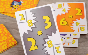 Настольная игра 7 на 9 Multi от Sovabooks для семейных развлечений, изображение коробки и игровых элементов.