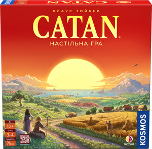 Настільна гра "CATAN" для стратегической игры, изображена коробка с названием и иллюстрациями на передней панели.